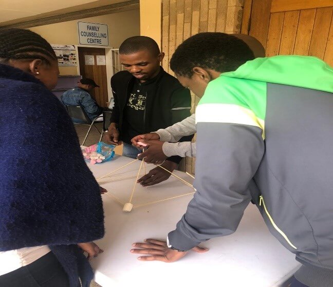 beneficiaries participating in an activity on team building facilitated by 3rd year psychology students from university of pretoria 2 (1)